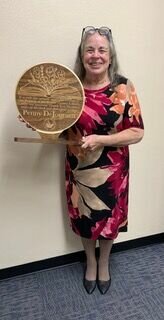 Penny DeJournet, BCRTSS program presenter, receives a plaque in recognition for her service to the Friends of the Boone County Library. CONTRIBUTED PHOTO