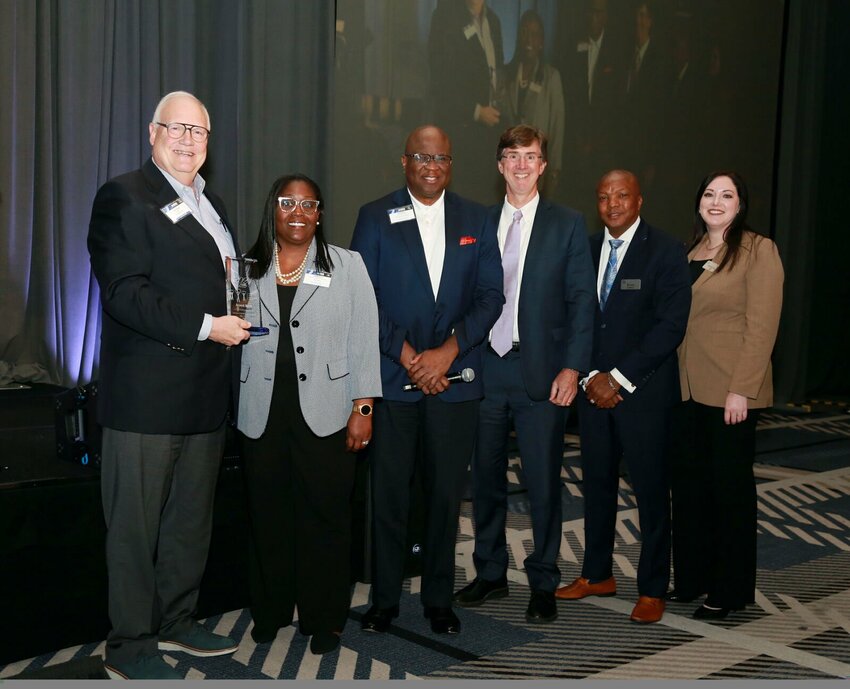 Arvest Bank receives the 2024 CARE Award from the Federal Home Loan Bank of Dallas. Tim Carter, left, FHLB board member stands with officials from Arvest Bank and FHLB Dallas. BUSINESS WIRE / MARIA OLIVAS