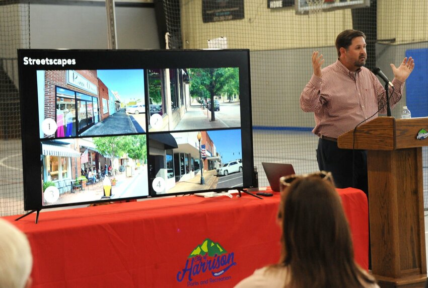Jeremy Murdock of Retail Strategies presents images to the crowd at a meeting about downtown improvement strategies this week. The crowd was asked to vote on which visuals they found most favorable by raising their hands. CONTRIBUTED PHOTO / LEE H. DUNLAP