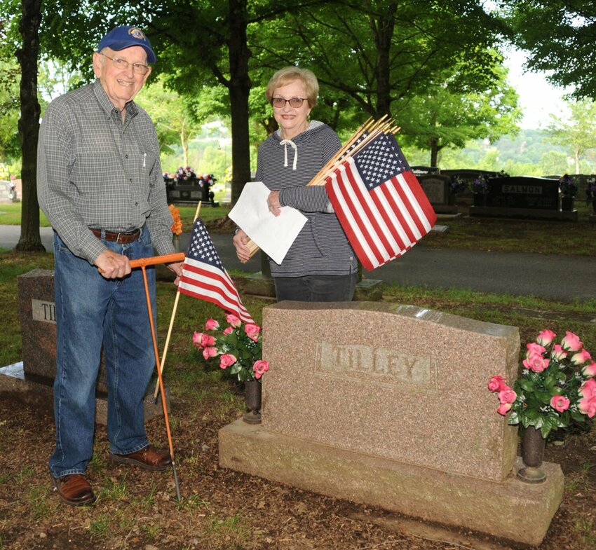 Dr. Charles and Jane Adair place flags on the grave sites of Veterans for Memorial Day. CONTRIBUTED PHOTO / LEE H. DUNLAP