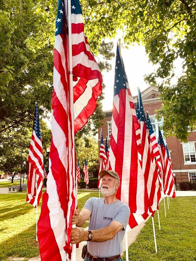 Fred Woehl helps with the display of American Flags at last year's (2023) Memorial Day event held on the Boone County Courthouse Courtpark. CONTRIBUTED PHOTO / LEE H. DUNLAP