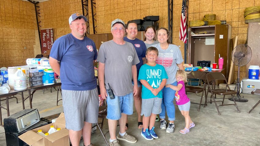 The Harmon Fire Station has supplies available to assist in tornado recovery. Helping to distribute these items on Thursday were (from left) Harmon Fire Department (HFD) firefighter Trigg Anderson, HFD assistant fire chief Alan Landrum, HFD firefighter Aubrey Jamerson, junior firefighter Andrea Jamerson, volunteer helper Rhett Lowery, HFD treasurer Kelsea Lowery, and volunteer helper Lainey Lowery. LORETTA KNIEFF / STAFF