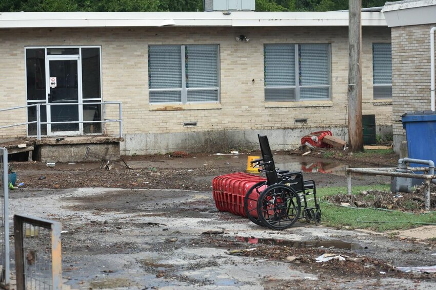 A wheelchair rests outside The Springs at Creekside in Yellville where flooding lead to the evacuation of the nursing home's residents on Wednesday. JEFF BRASEL / STAFF