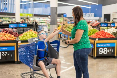 A 10-year-old child rides in a Caroline’s Cart — a specially designed cart created to meet the needs of disabled individuals, including adults. The retailer has introduced the specially designed carts in all stores statewide and plans to have them in all stores nationwide. CONTRIBUTED PHOTO