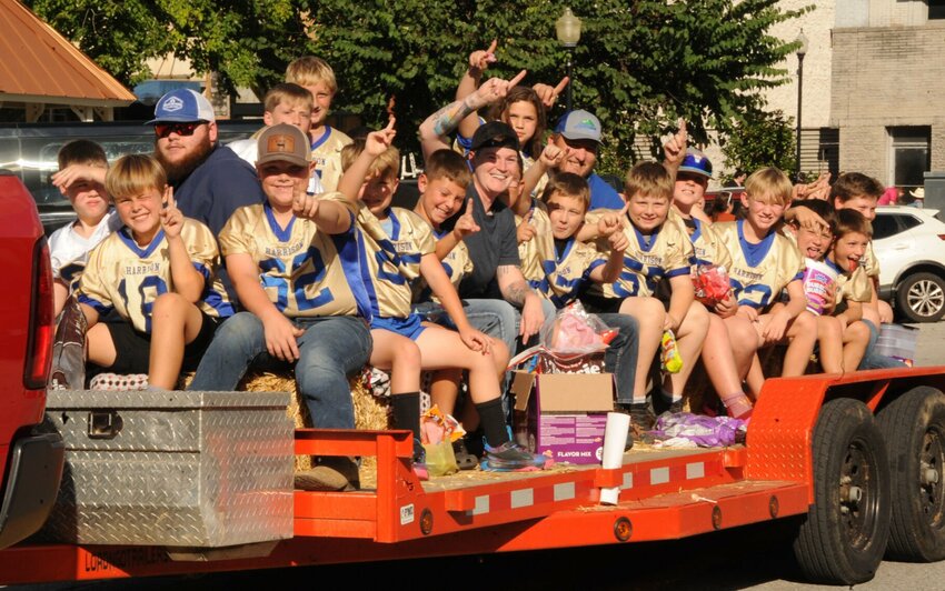 Harrison Hogs football team shows enthusiasm as they ride in Harrison's rodeo parade on Thursday, Sept. 26. CONTRIBUTED PHOTO / LEE H. DUNLAP