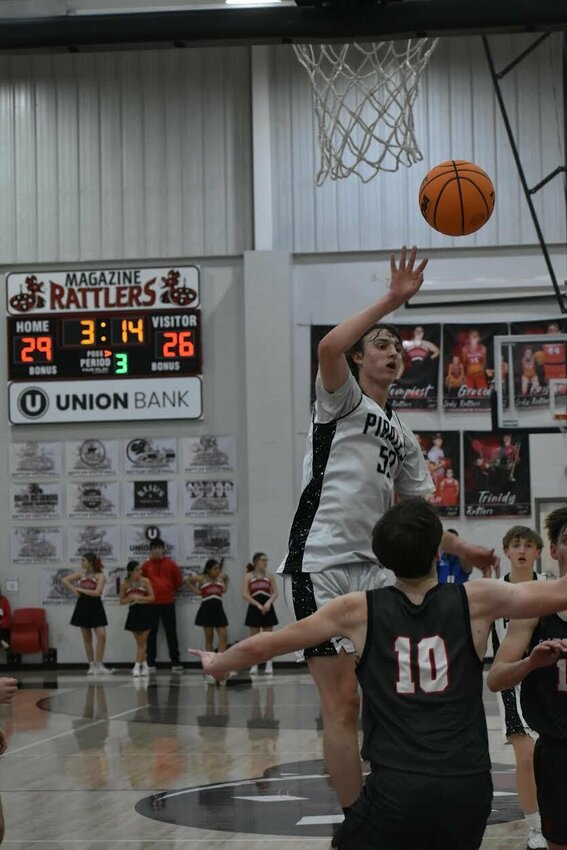 JEFF BRASEL/STAFF   Spencer Traywick of Jasper dumps the basketball down low during play at Magazine High School. Traywick and the Pirates finished as runner-up in Class 1A Region Tournament. The team will now play Blevins on Wednesday in the Class 1A State Basketball Tournament in Trumann.