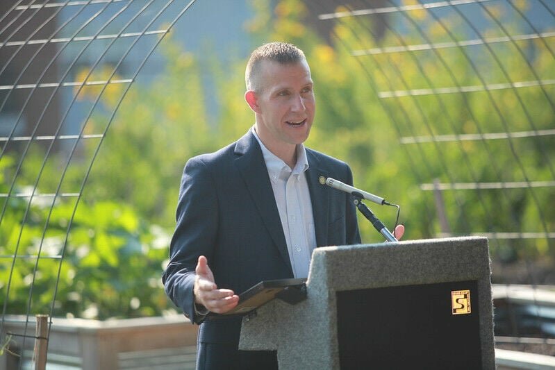 Arkansas Agriculture Secretary Wes Ward presents the Governor's proclamation, declaring Aug. 1-7 Arkansas Farmers' Market Week, at the UALR Community Garden in Little Rock. CONTRIBUTED PHOTO