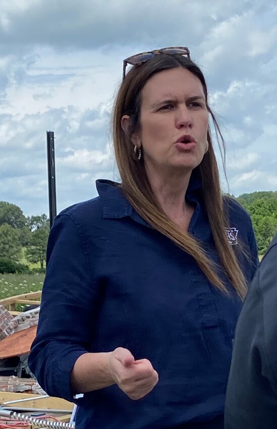 Governor Sarah Huckabee Sanders appears at a photo opportunity following tornado damage in Boone County in 2024.