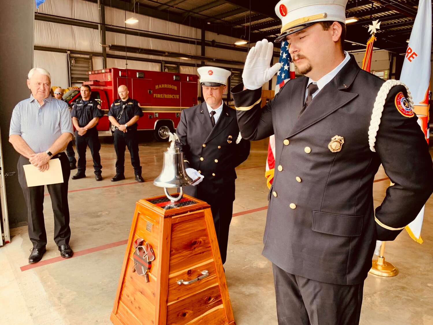 Harrison Fire Department Honor Guard member including Lt. Lindsey Harp (right) salute as Lt. Seth Estes rings the bell during the 9/11 Ceremony held Monday at the Central Fire Station at the Harrison City Hall on Industrial Park Road. At left is Harrison Mayor Jerry Jackson. CONTRIBUTED PHOTO/LEE H. DUNLAP