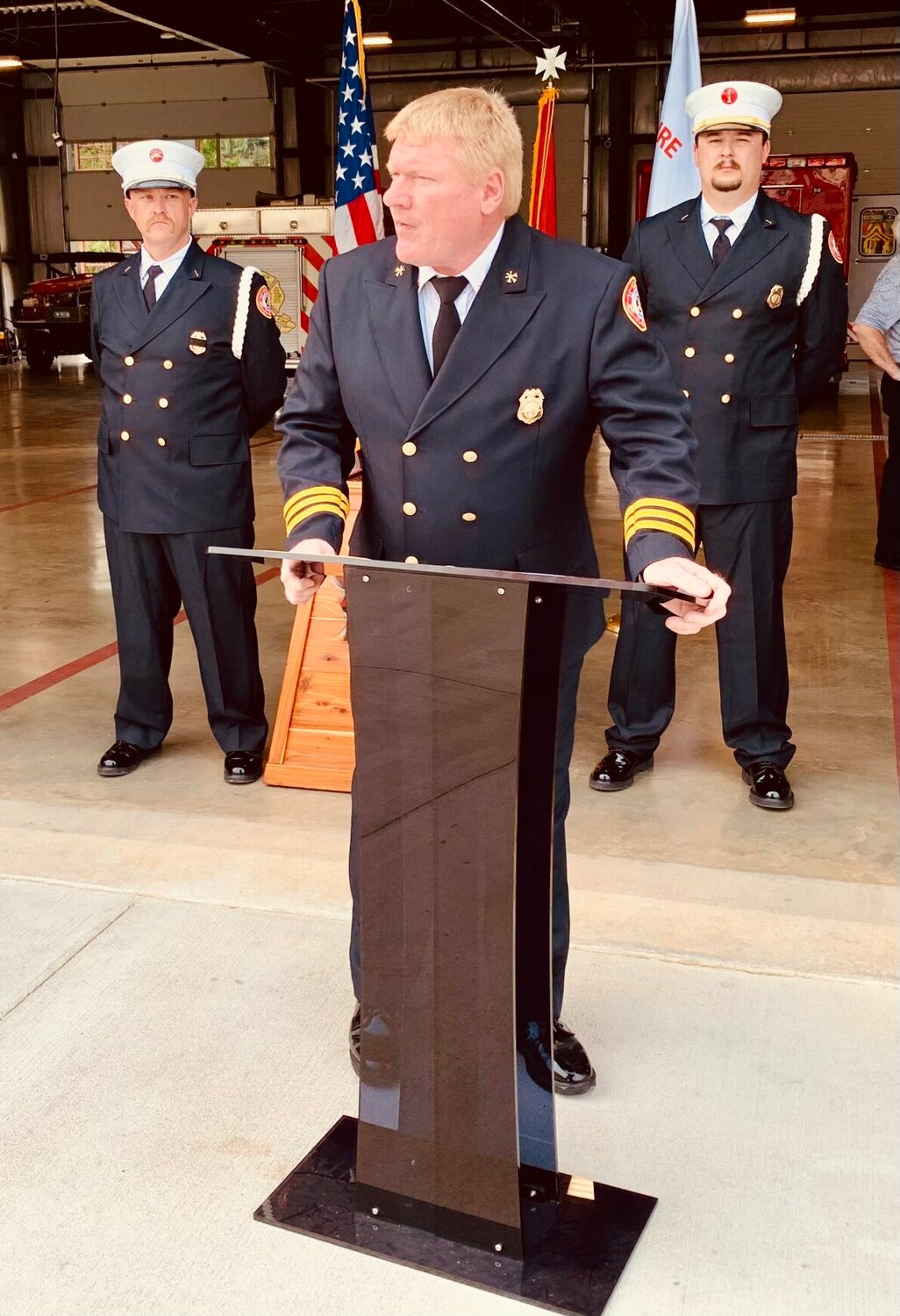 Ron Lemley, a Battalion Chief at the Harrison Fire Department, gave the welcoming remarks to the large group of people who attended the 9/11 Ceremony at the Harrison Fire Station Monday morning. Behind Lemley are Lt. Lindsey Harp (left) and Lt. Seth Estes. They are members of the Harrison Fire Department’s Honor Guard. CONTRIBUTED PHOTO/LEE H. DUNLAP