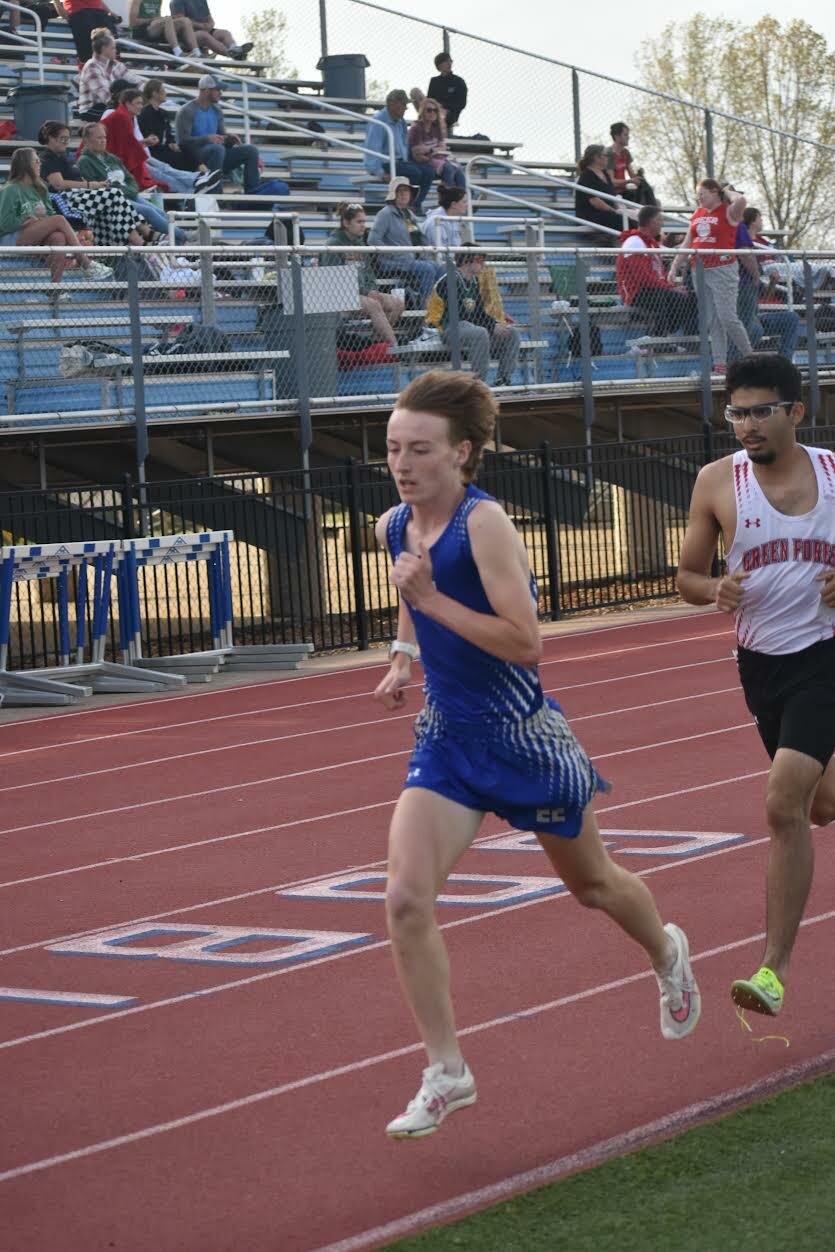 Harrison freshman Hunter Frickle (left) moves in front of Green Forest senior Arauny Reyes in the second lap of the 1600 Meter Run at Harrison High School on Thursday night.. Frickle won the event and then later won the 3200 Meter Run by 50 seconds. JEFF BRASEL / STAFF