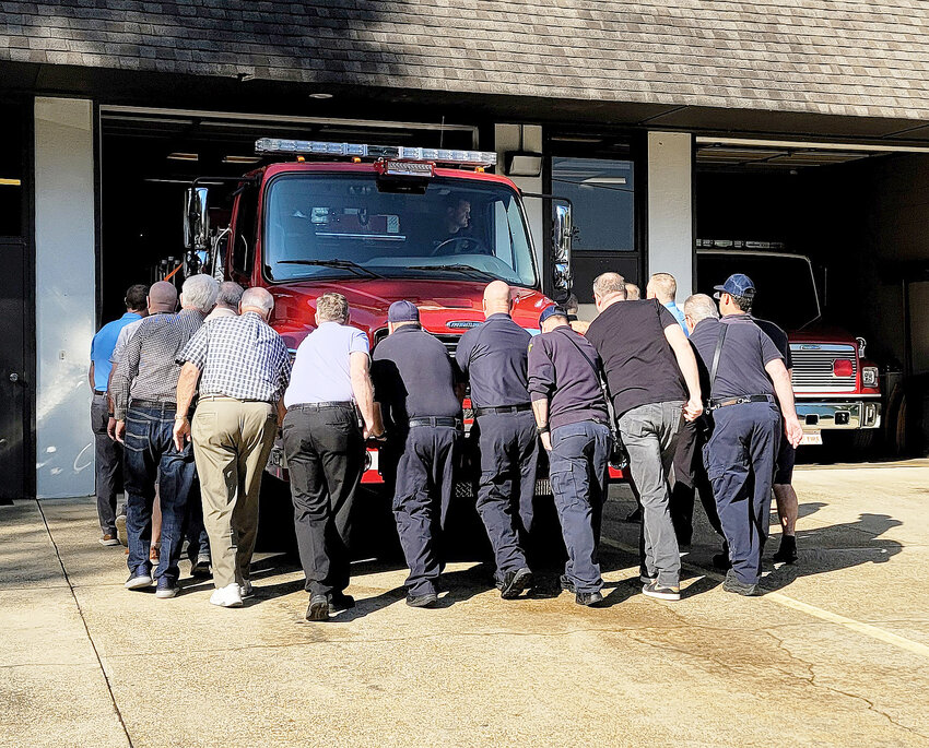 Members of the community assist firefighters and police officers in the “push-in” ceremony to celebrate the addition of Engine 5 to the HSV Fire Department fleet. (Mary Eliades photos)