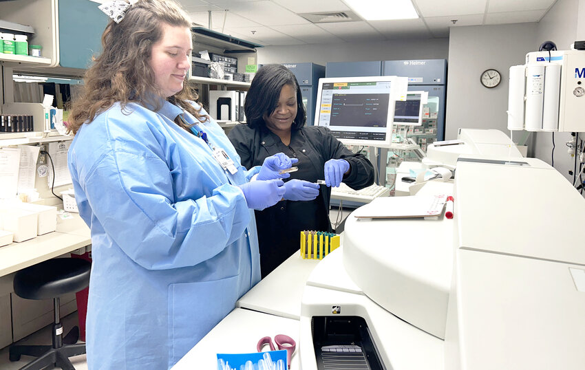 Shelby Dalton, medical technologist,  from left, and Mercedes Woods, laboratory assistant, prepare samples for testing on the chemistry analyzer. (Submitted photo)