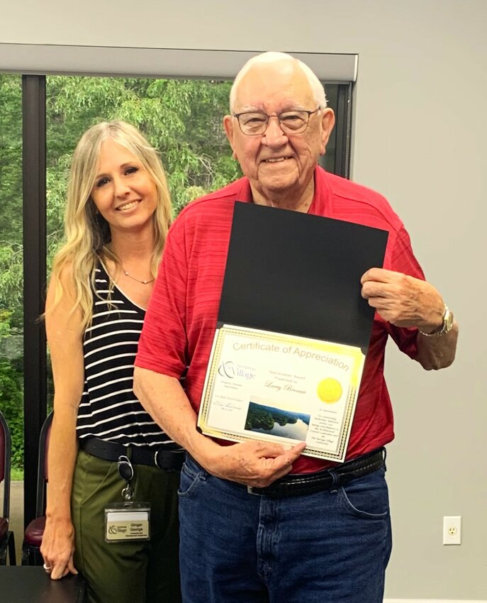 Larry Brocaw, steps down as chairman of the ACC. Ginger George, 
Supervisor of Contracts and Development for the HSV POA presents Brocaw with a letter of appreciation and a certificate to commemorate the occasion. (Suzanne Sweeten photo)