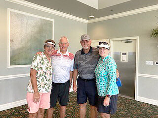 Winners of the “Knock Your Socks Off” flight. Kathy Carter, Caddie Steve St. Onge, Caddie Charles Veazey, Patsy Veazy.