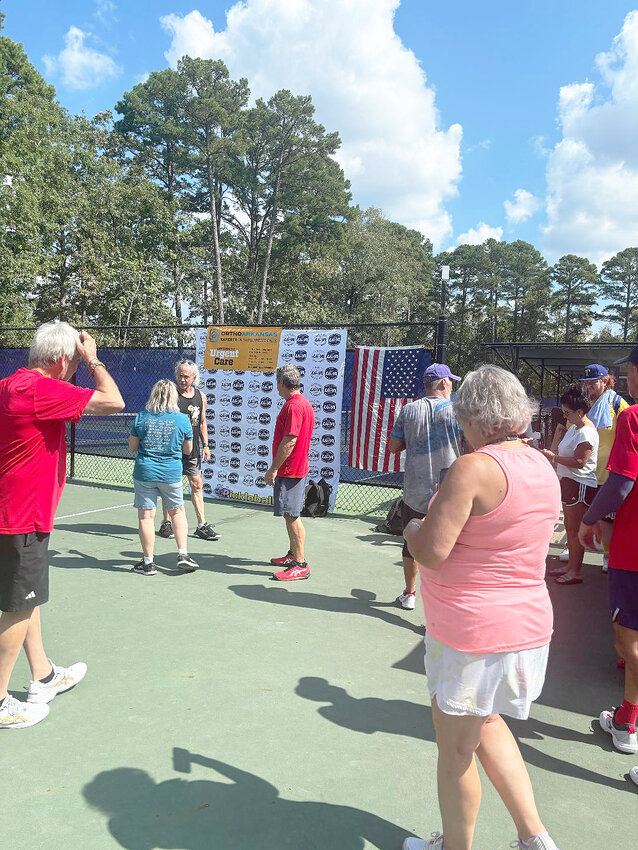 Pickleball players and tournament attendees mingle after their matches.