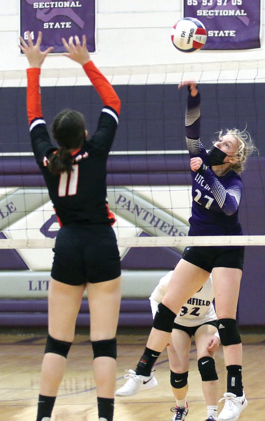 Litchfield freshman Annika Rhodes tries to slip a hit past the block of Hillsboro's Alayna McCario (#11) during the rivalry showdown on Thursday, April 8. Rhodes and the Panthers would win game one, 25-22, but McCario's Toppers got the win with back-to-back 25-20, 25-19 victories.