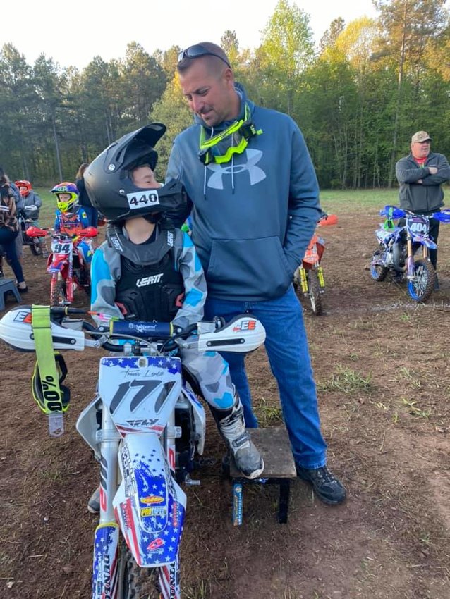 Travis Lentz and his dad, Jay, talk things over before Travis' run on the Tiger Run course at Big Buck Farm in Union, SC, the fifth round of the Grand National Cross Country series&nbsp; on April 17-18.