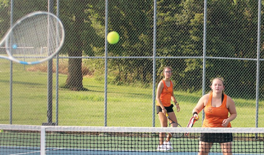 Hillsboro seniors Ruthie Mathews (left) and Macy Shipman wait to see the direction of the return from the Greenville side during their doubles match with Paige Mathias and Evie Johnson on Tuesday, Aug. 31. The match would be a tough one for the Toppers, who fell to their South Central Conference foes 9-0.