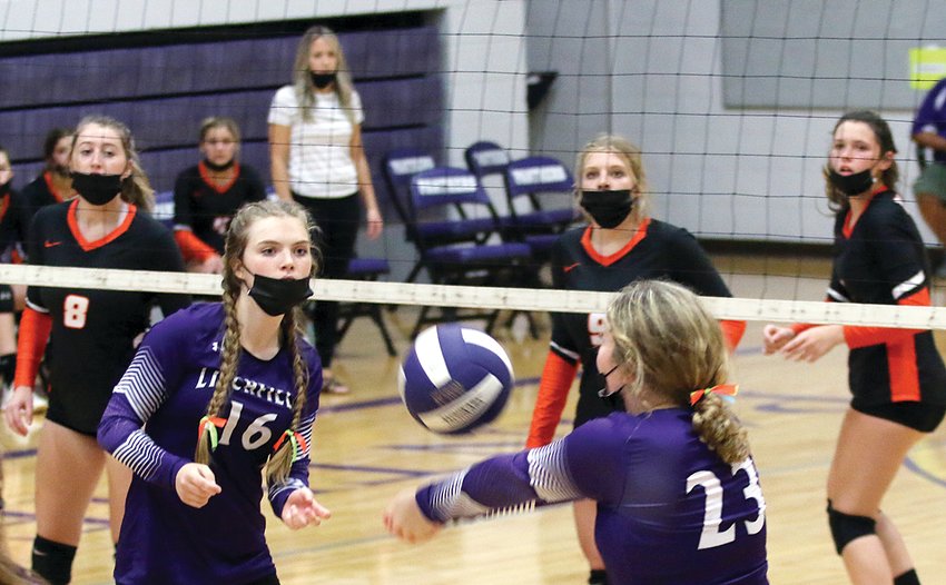 With Hillsboro's Adyson McCammack (#8), Sophia Blankenship (#9) and Emilee Roemelin waiting on the other side, Litchfield's Ashley Hickerson looks to set up fellow senior Taylor Brakenhoff in game two against the Hiltoppers on Thursday, Sept. 2. After taking game one 25-16, Litchfield carried the momentum on to game two, winning 25-21 to end a 14-game losing streak against Hillsboro.