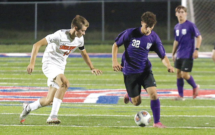 Lincolnwood defender Braden Whalen tries to track down Carlinville forward Trieton Park during the first half of the Kickin&rsquo; For A Cure game in Carlinville on Oct. 4. Park would have three second half goals to lead the Cavaliers to a 5-0 win over the Lancers.
