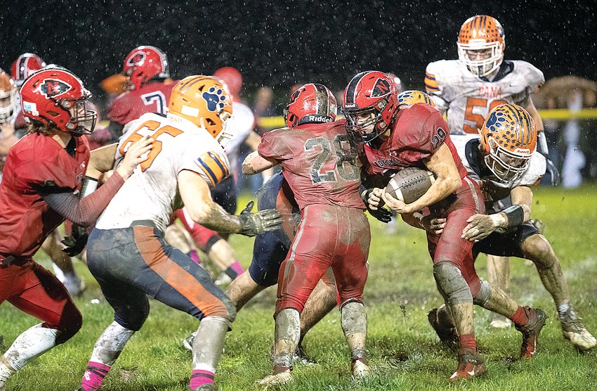 Through the pouring rain, Nokomis' Matthew Hill drives forward for a few extra yards during the Redskins' week eight contest against Pana on Oct. 15. Hill and the Redskins put up a fight against the undefeated Panthers before falling 17-0 on the friendly, but sloppy, confines of Redskin Field.
