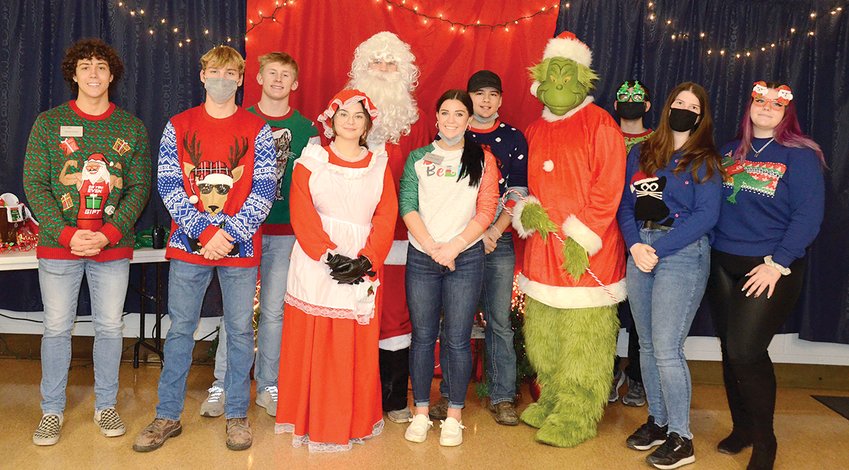 Dressed in their holiday finest, students in the Montgomery CEO program served over 120 meals as part of their class business project on Sunday evening, Dec. 5, in Hillsboro. Pictured above, in front, from the left are Ethan Lentz, Matthew Hill, Elaan Bader, Presley Lamb, Cora Stevens and Samantha Jackson. In back are Landon Engelman, Luke Webb, Kaden Weakley, the Grinch (Don Downs) and Tim Ensley. Cameron Crow was not present for the photo.