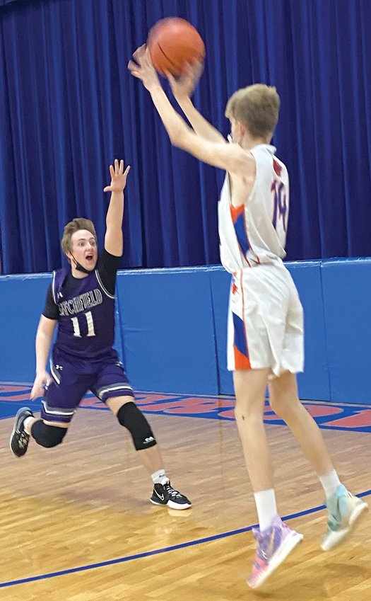 Litchfield's Kelvin Dooley (#11) rushes out to contest Dustin Steiner's three-point attempt during the Panthers' game in Mulberry Grove on Friday, Dec. 3. Litchfield picked up a 60-32 victory over the Aces on the road to improve to 2-3 on the young season.