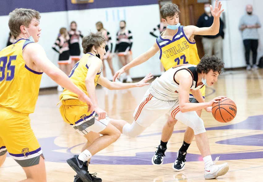 Hillsboro's Jace Stewart dribbles through traffic during the fifth place game at the Rick McGraw Memorial Invitational on Saturday, Jan. 22, in Litchfield. The Toppers finished the 16-team tournament in sixth place, falling to Taylorville 66-34 in their final game.