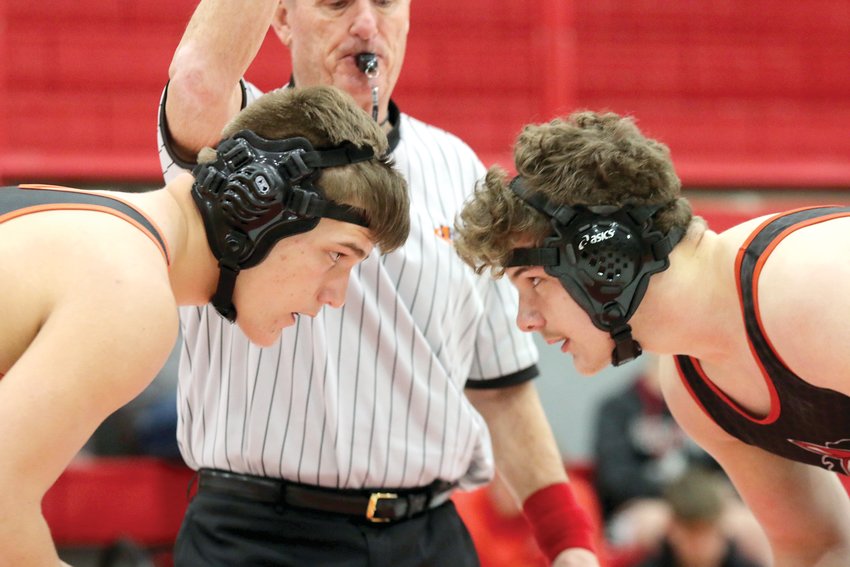 With a state berth already secured, Hillsboro's Magnus Wells (left) and Fairfield's Payton Allen (right) await the whistle from the official during their 220-pound sectional championship match in Vandalia on Feb. 12. Down 4-3 in the third, Wells shot in for a double-leg takedown and scored a win by fall 40 seconds later to secure Hillsboro's first IHSA sectional title in 13 years.