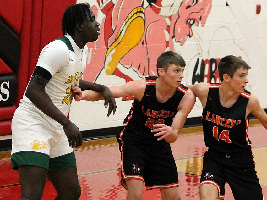 All 6'8&quot; of Metro-East Lutheran's Damarcus Bean not only took up space, but took Lincolnwood's defensive attention, including that of Gabe Armentrout (center) and Braden Whalen (right), which allowed the Knights some opportunities from outside the arc in the Hardin Regional semifinal on Wednesday, Feb. 23. The Edwardsville-based private school hit nine threes in their 56-28 victory over Lincolnwood to advance to Friday's regional championship.