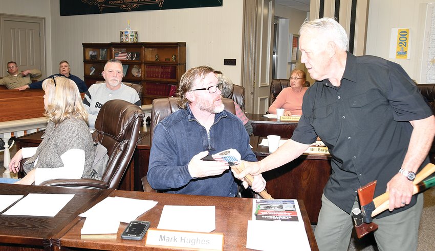 Bob Buda of Litchfield brought several American made items to the Montgomery County Board meeting on Tuesday evening, March 8. Pictured above, he shows some handmade axes to board member Mark Hughes of Hillsboro. Buda made a presentation asking the board to consider a resolution to make the motto of Montgomery County, &ldquo;A Center for American Made.&rdquo;