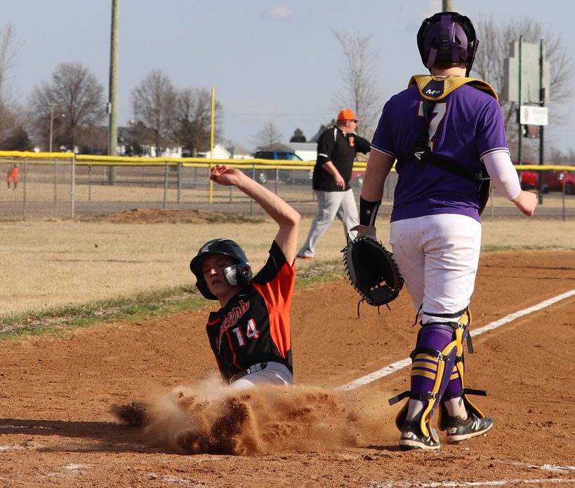 Lincolnwood&rsquo;s Braden Whalen slides into home plate for the first run of the season for the Lancers in the opening inning of their game with Taylorville on March 15. Whalen would have two runs and two hits in the game, which Taylorville won 11-9.