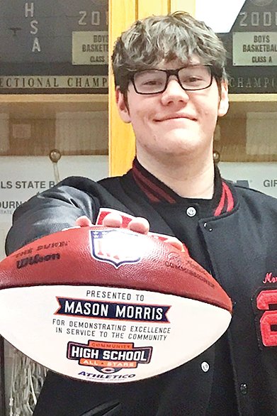Mason Morris is pictured above with the custom hand-painted football he received as part of the award.