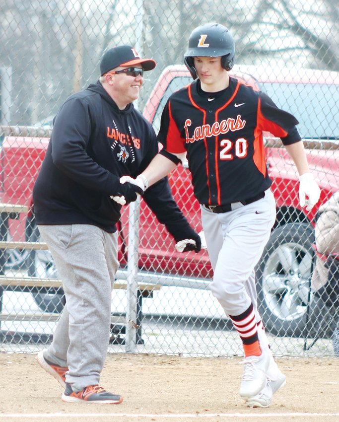 Lincolnwood Head Coach Josh Stone congratulates Lance Weitekamp as the Morrisonville junior rounds third base following his two-run home run in Edinburg on Tuesday, March 29. Weitekamp went 4-for-4 with four runs driven in during the Lancers 15-4 victory over the Wildcats, game one of a doubleheader sweep on Tuesday.