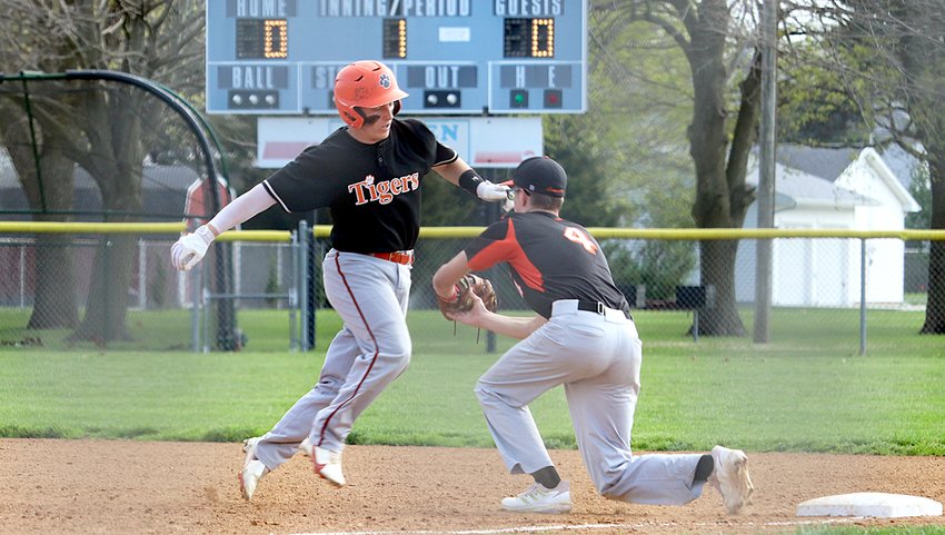Greenfield-Northwestern's Brady Pembrook tries to escape the tag of Lincolnwood firstbaseman Jared Klein during the Lancers' home game in Raymond on April 23. While the Lancers caught Pembrook leaning on this play, the Tiger senior went 2-for-3 with three runs scored as Greenfield-Northwestern knocked off the Lancers 12-1 for their 16th win of the year.