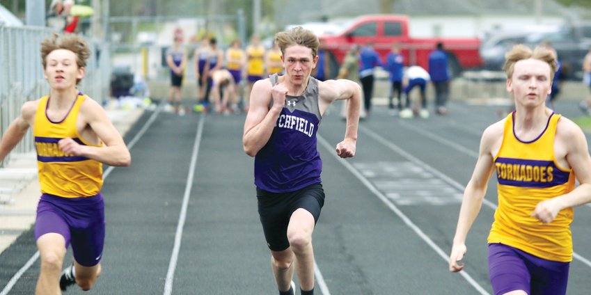 Sandwiched between two Taylorville runners, Litchfield's Zach Leitschuh keeps his eyes on the finish line of the 100 meter dash during the Panthers' meet on Thursday, April 28. Leitschuh finished eighth in the 100 as the Litchfield boys went on to finish second in their home meet.