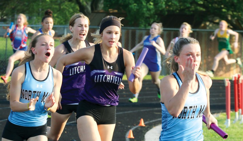 Litchfield senior Carly Guinn (second from the left) offers some encouragement to teammate and fellow senior Lily Braasch after handing off the baton in the final leg of the 4x100 relay at the Gillespie Sectional on Thursday, May 12. Braasch stopped the clocks at 52.02 seconds, helping the Panthers to a second place finish and a state qualifying spot. Sofia Ray and Kendall Stewart ran the first two legs of the relay, which was one of seven state qualifying entries for Litchfield on Thursday.