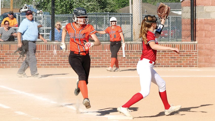 Hillsboro&rsquo;s Ella Greenwood sprints to first to beat the throw from short by a step in the Toppers&rsquo; regional quarterfinal game against Vandalia on May 16. Playing on their home field, the Vandals scored in five of the six innings to end Hillsboro&rsquo;s season with an 11-3 defeat.