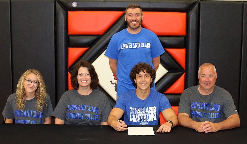 Ethan Lentz (seated), recently made his decision to play soccer for Lewis and Clark Community College official once his time at Hillsboro High School is complete. Joining Lentz were his sister, Reagan Lentz, parents Brandi and Matt Lentz, and Hillsboro High School boys soccer coach, Jason Burke.