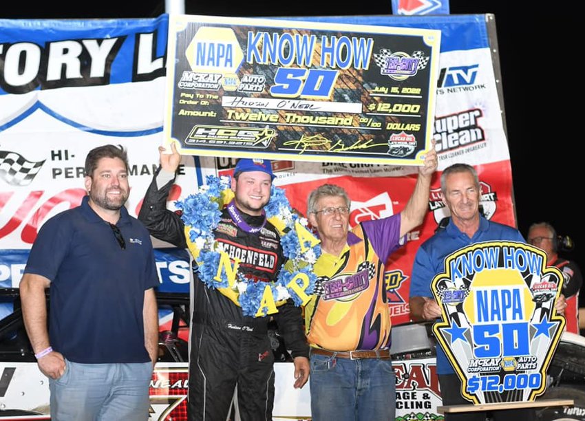 A big check was on the line on Friday, July 15, as drivers from the Lucas Oil Late Model Dirt Series competed for $12,000 to win the NAPA Know How 50 at Tri-City Speedway in Granite City. From the left are Matt McKay of McKay NAPA Auto Parts, race winner Hudson O&rsquo;Neal, Tri-City Speedway owner Kevin Gundaker and McKay NAPA Auto Parts President and CEO Earl Flack.