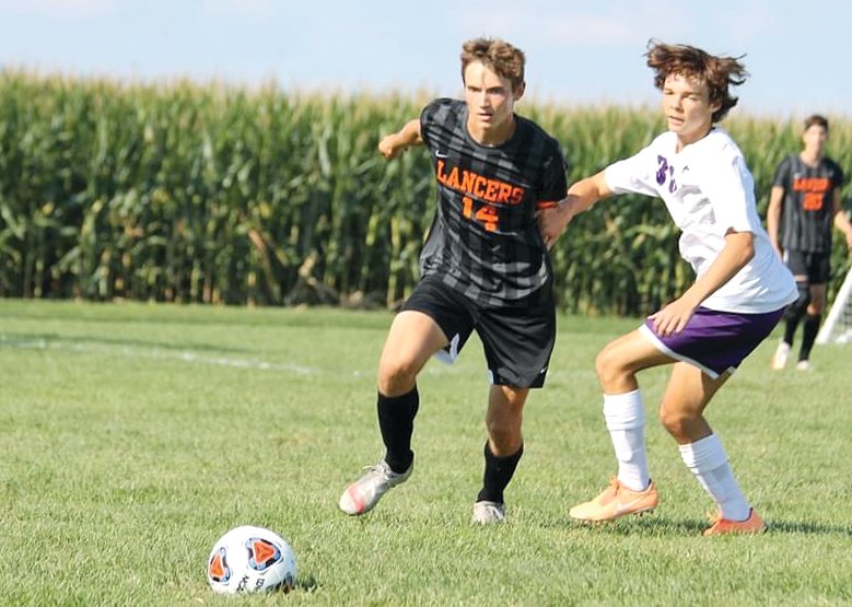 Lincolnwood&rsquo;s Braden Whalen (left) and Litchfield&rsquo;s Drake Gasperson eye a loose ball during their match-up on Tuesday, Aug. 23, in Raymond. The Lancers scored four times in the first half and four more times in the second for the second straight game as they defeated the Panthers 8-1 to improve to 2-0 on the season.