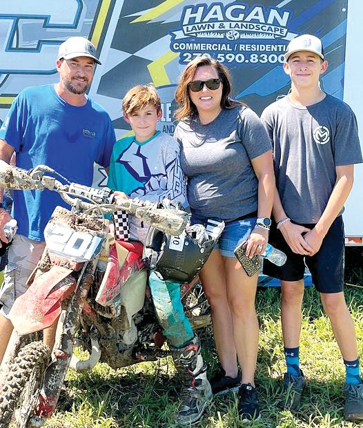 Cooper Duff, on the #201 Gas Gas motorcyle, took first at round six of the Mid-South Cross Country Series on Saturday, Aug. 13, clinching the overall points title for the series in the 85cc Sr. class. Pictured with Duff are his parents, Ryan and Rachel, and older brother Zach.