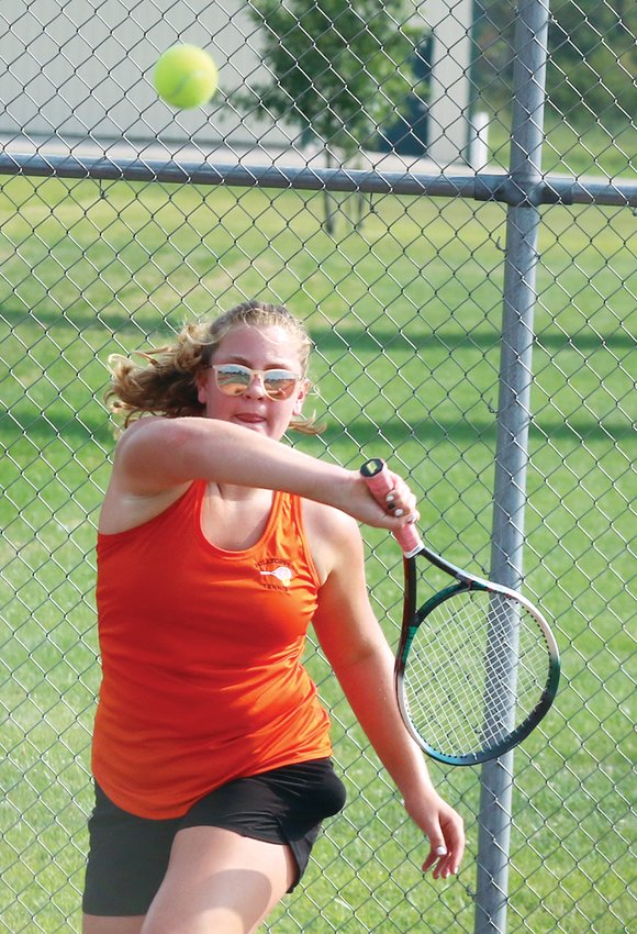 Hillsboro sophomore Aubrey Reincke returns a shot during her match with Megan Corlew of Triad during the Toppers' home opener on Thursday, Aug. 25. Reincke is one of nine freshmen or sophomores on this year's tennis roster, which also includes three seniors and five juniors.