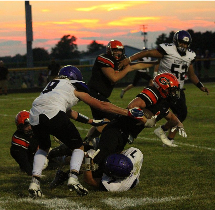 As the sun sets over Don Dobrino Field in Gillespie, Litchfield's A.J. Sypherd hauls down a Gillespie ball carrier during the Panthers' home opener on Aug. 26, against the Miners. On the other side of the ball, Sypherd had 105 yards rushing and two touchdowns in Litchfield's 24-18 loss.