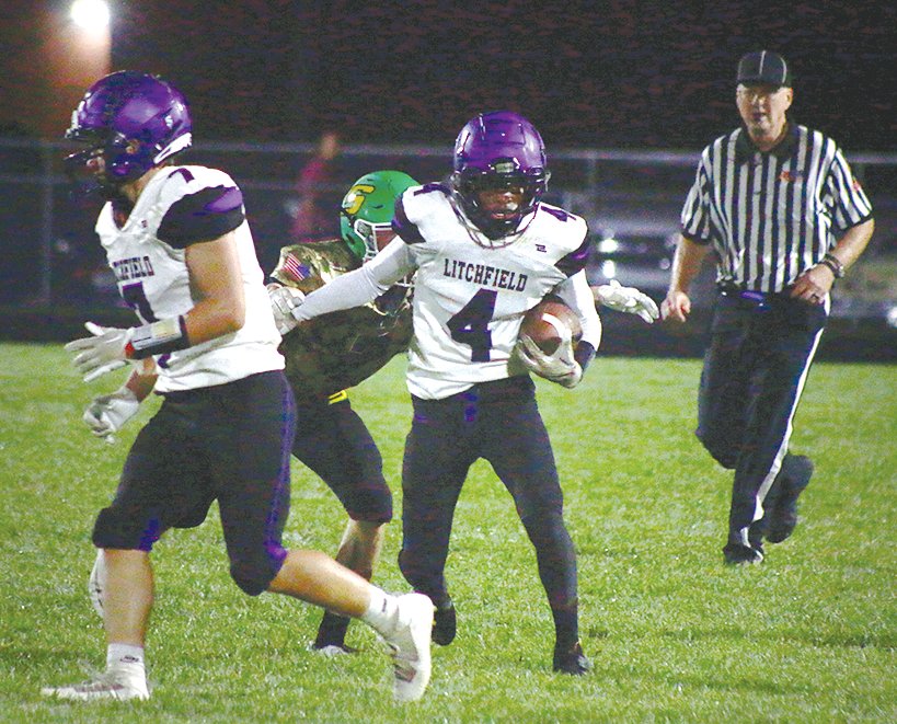 Litchfield safety Keenan Powell (#4) looks for running room after intercepting a pass in the Purple Panthers' 40-6 loss to Southwestern on Friday, Sept. 9.