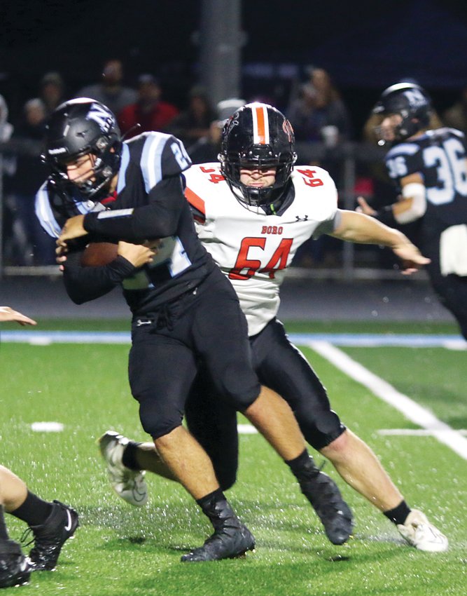 Hillsboro's Reese Morford bears down on North Mac running back Zane Hogan during the Toppers' road trip to Virden on Friday, Sept. 23. Hogan had 200 yards on 11 carries in the Panthers' 38-0 win over the Toppers.
