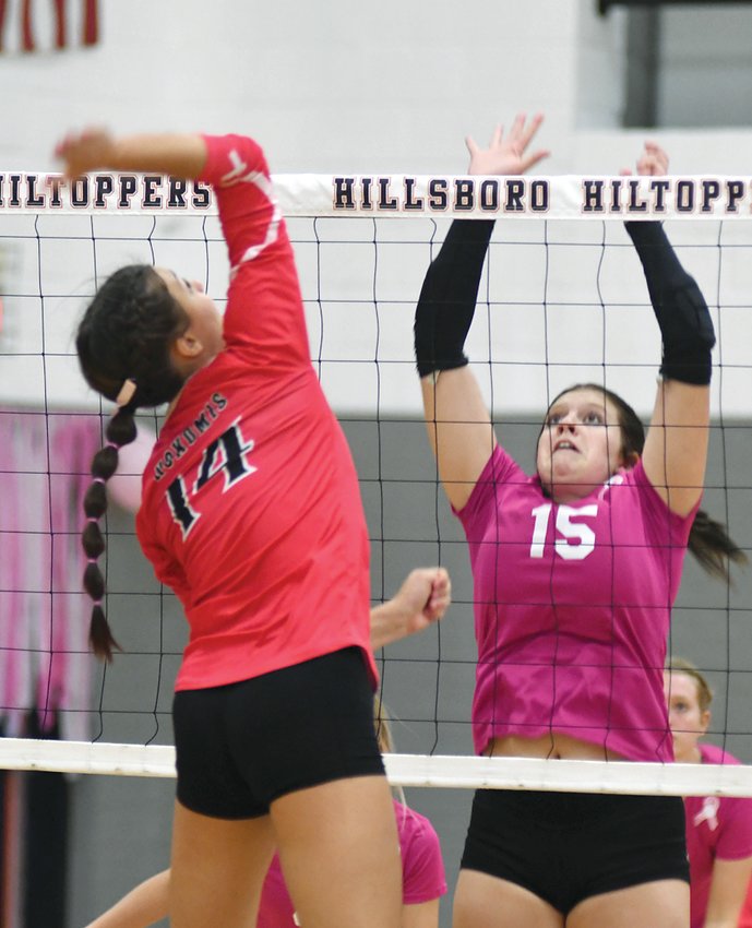 Hillsboro's Sophia Blankenship goes up for a block against Nokomis' Addison Glenn during the two Montgomery County squads' game in Hillsboro on Monday, Sept. 26. The home team would escape with a 25-18, 25-23 win over the Lady Redskins on Dig for a Cure Night.