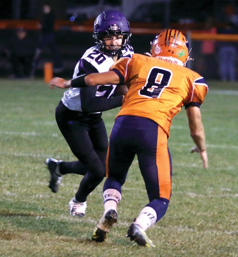 Litchfield wide receiver Easton Grammer looks for a way around Pana defender Carter Beyers after catching a pass in the second quarter of the Purple Panthers' 42-8 loss to Pana.