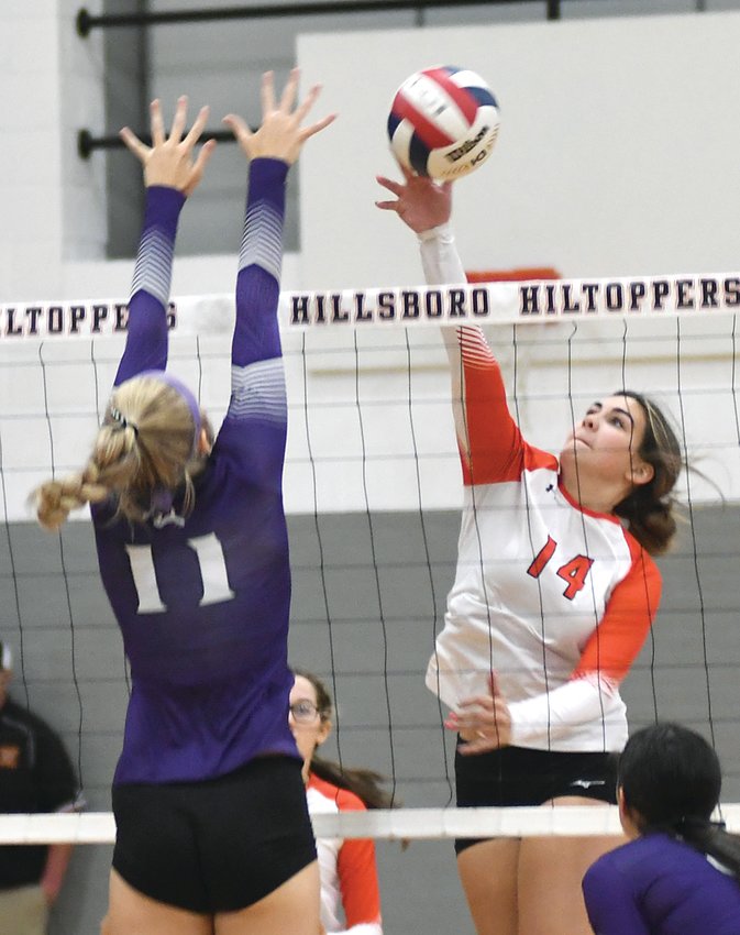 Hillsboro's Addison Lowe (#14) tries to sneak past the block of Litchfield's Carlee Harmon (#11) during the rivals' game on Tuesday, Oct. 11, in Hillsboro. Harmon and company defeated the Toppers for the second time this season, this time earning a South Central Conference victory in the process.